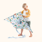 Boy playing with dinosaur kite
